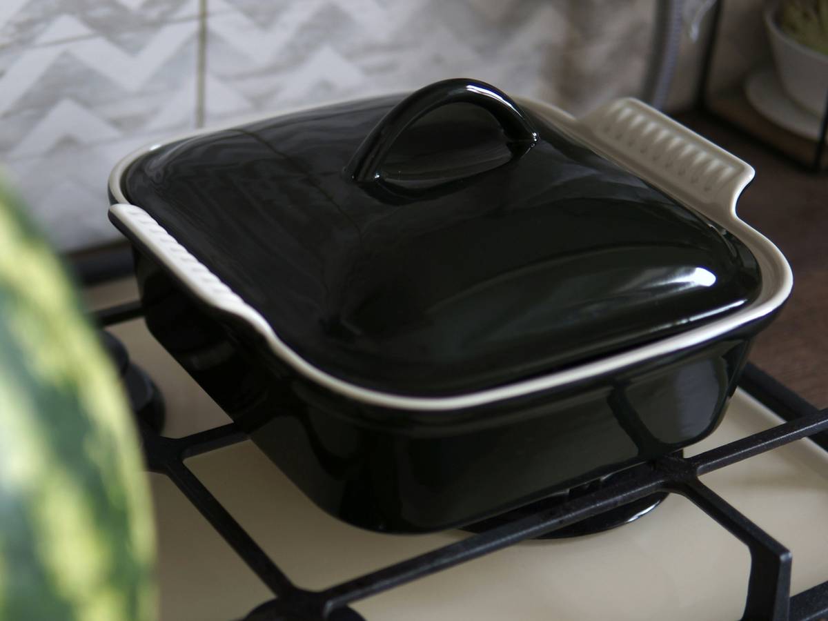 Stacked pyrex rectangle dishes in kitchen cabinet showing space efficiency